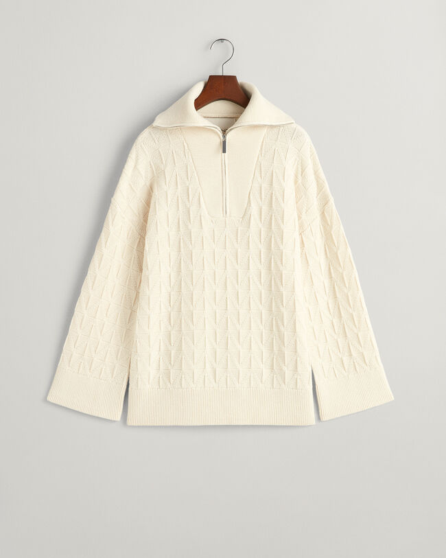 Kalanruotokuvioinen neulepusero, jossa vetoketjullinen pääntie