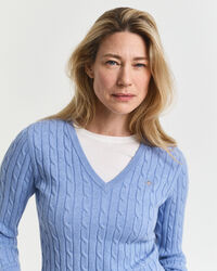 Joustava puuvillapalmikkoneule, jossa v‑pääntie