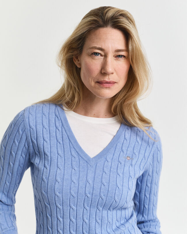 Joustava puuvillapalmikkoneule, jossa v‑pääntie