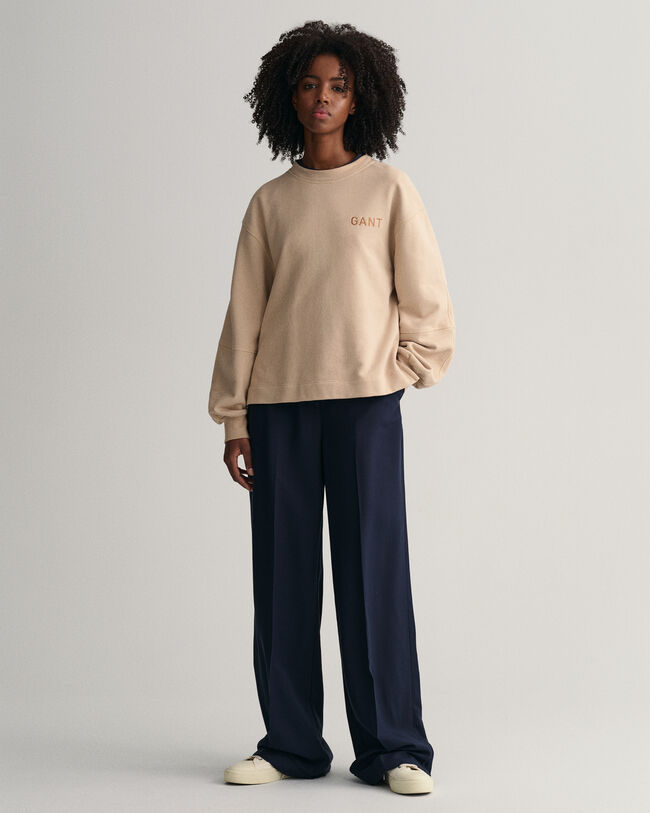 Logolla varustettu väljähihainen collegepaita