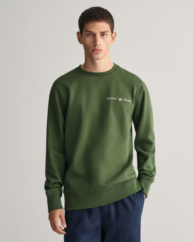 Py&ouml;re&auml;ll&auml; p&auml;&auml;ntiell&auml; ja painatuksella varustettu collegepaita