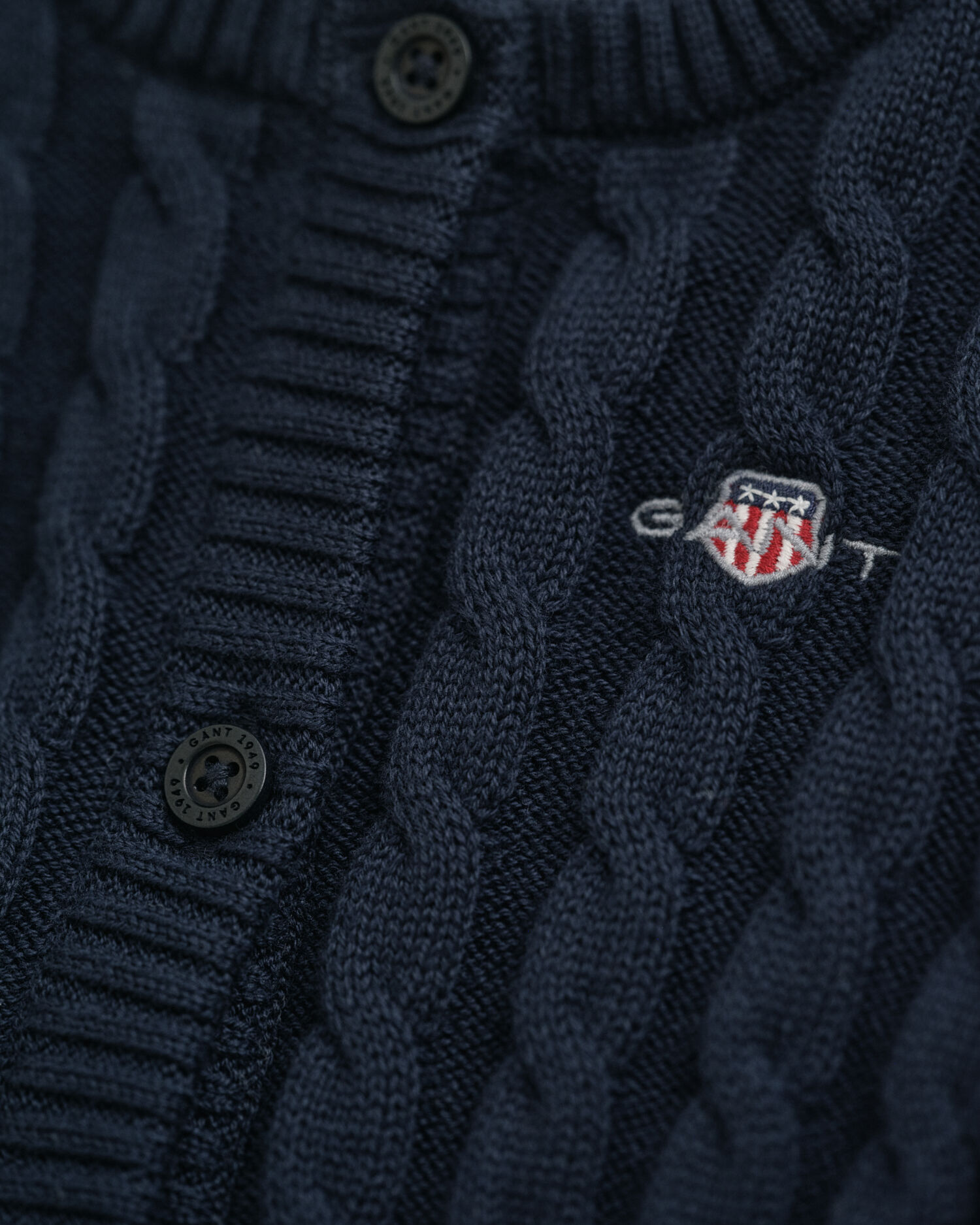 Baby-malliston puuvillainen Shield-palmikkoneuletakki