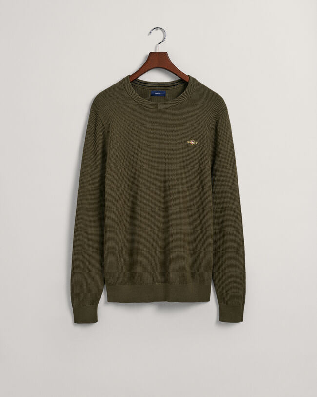 Kohopintainen puuvillaneulepusero, jossa py&ouml;re&auml; p&auml;&auml;ntie