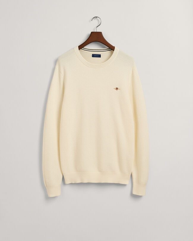 Kohopintainen puuvillaneulepusero, jossa py&ouml;re&auml; p&auml;&auml;ntie