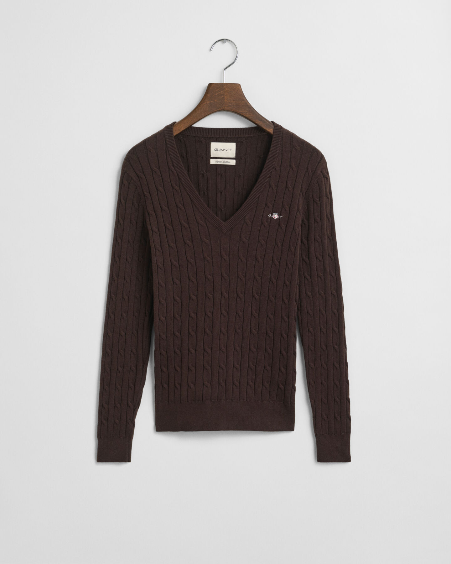 Joustava puuvillapalmikkoneule, jossa v‑pääntie