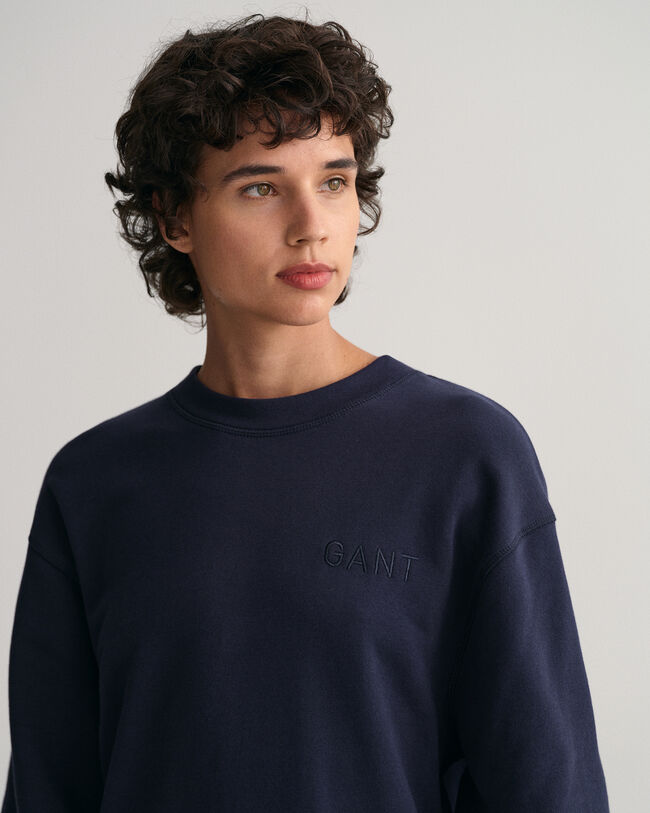 Logolla varustettu v&auml;lj&auml; pitk&auml;hihainen mekko