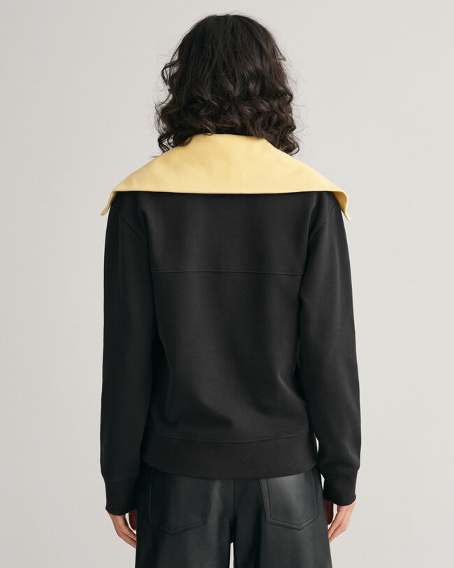 Oversized fit -mitoitettu collegepaita, jossa vetoketju p&auml;&auml;ntiell&auml; ja v&auml;ripintoja