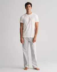 Raidalliset pyjamahousut ja t‑paita lahjapakkauksessa