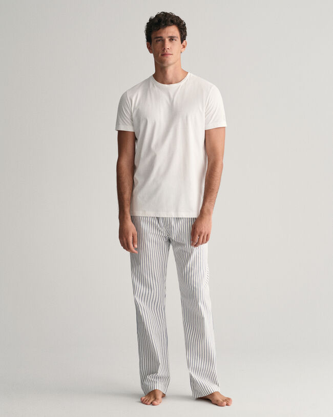 Raidalliset pyjamahousut ja t‑paita lahjapakkauksessa