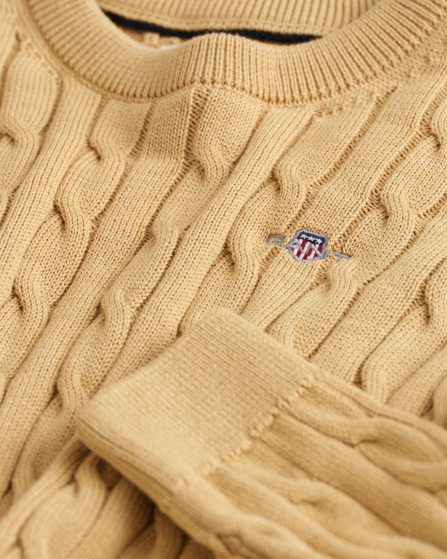 Kids-malliston puuvillainen Shield-palmikkoneulepusero, jossa py&ouml;re&auml; p&auml;&auml;ntie