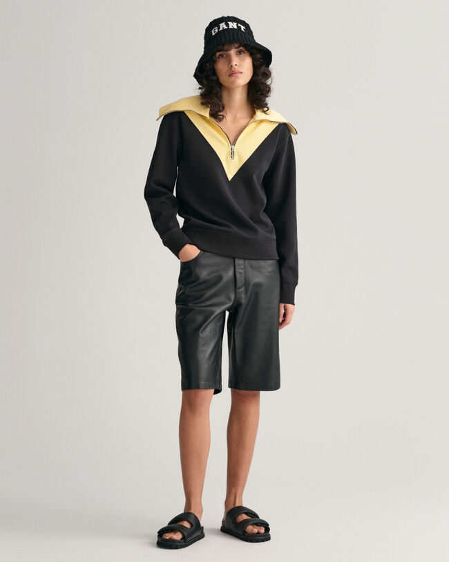 Oversized fit -mitoitettu collegepaita, jossa vetoketju p&auml;&auml;ntiell&auml; ja v&auml;ripintoja