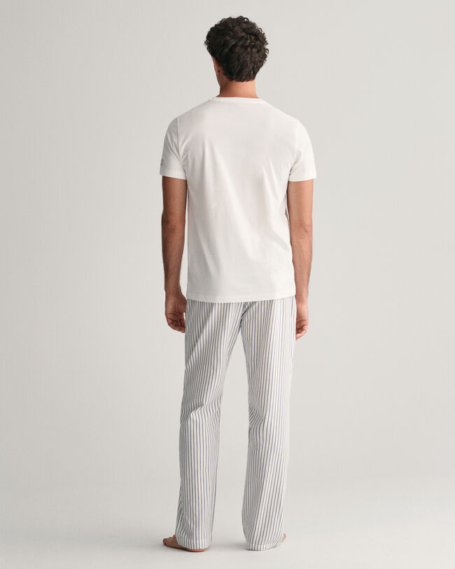 Raidalliset pyjamahousut ja t‑paita lahjapakkauksessa