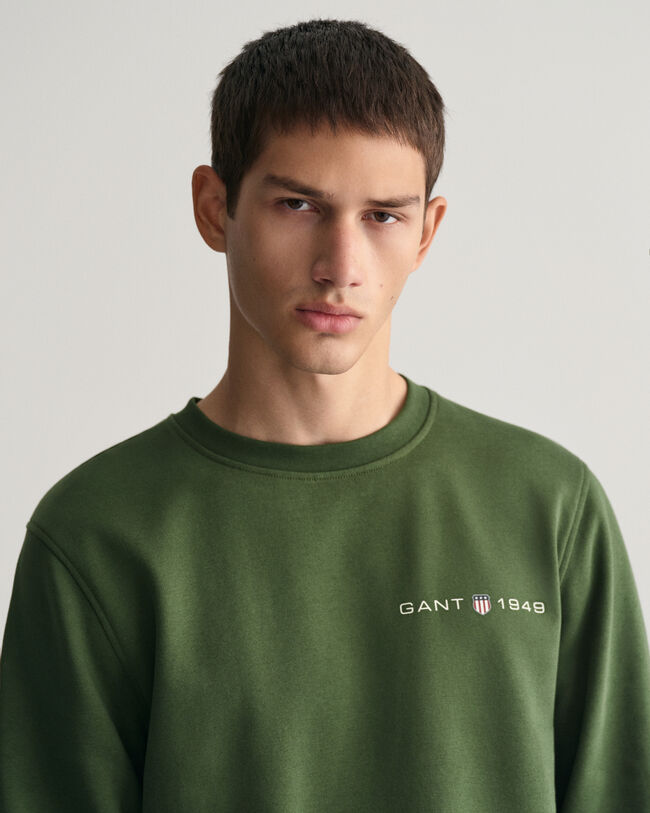 Py&ouml;re&auml;ll&auml; p&auml;&auml;ntiell&auml; ja painatuksella varustettu collegepaita