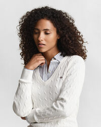 Joustava puuvillapalmikkoneule, jossa v‑pääntie