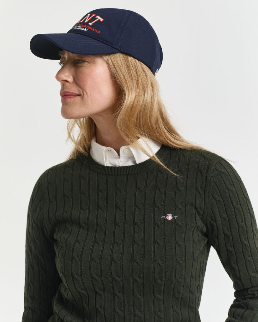 Joustopuuvillainen palmikkoneulepusero, jossa pyöreä pääntie