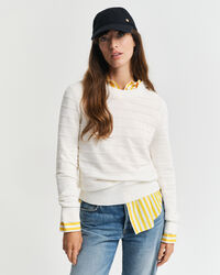 Kohopintainen puuvillaneulepusero, jossa pyöreä pääntie