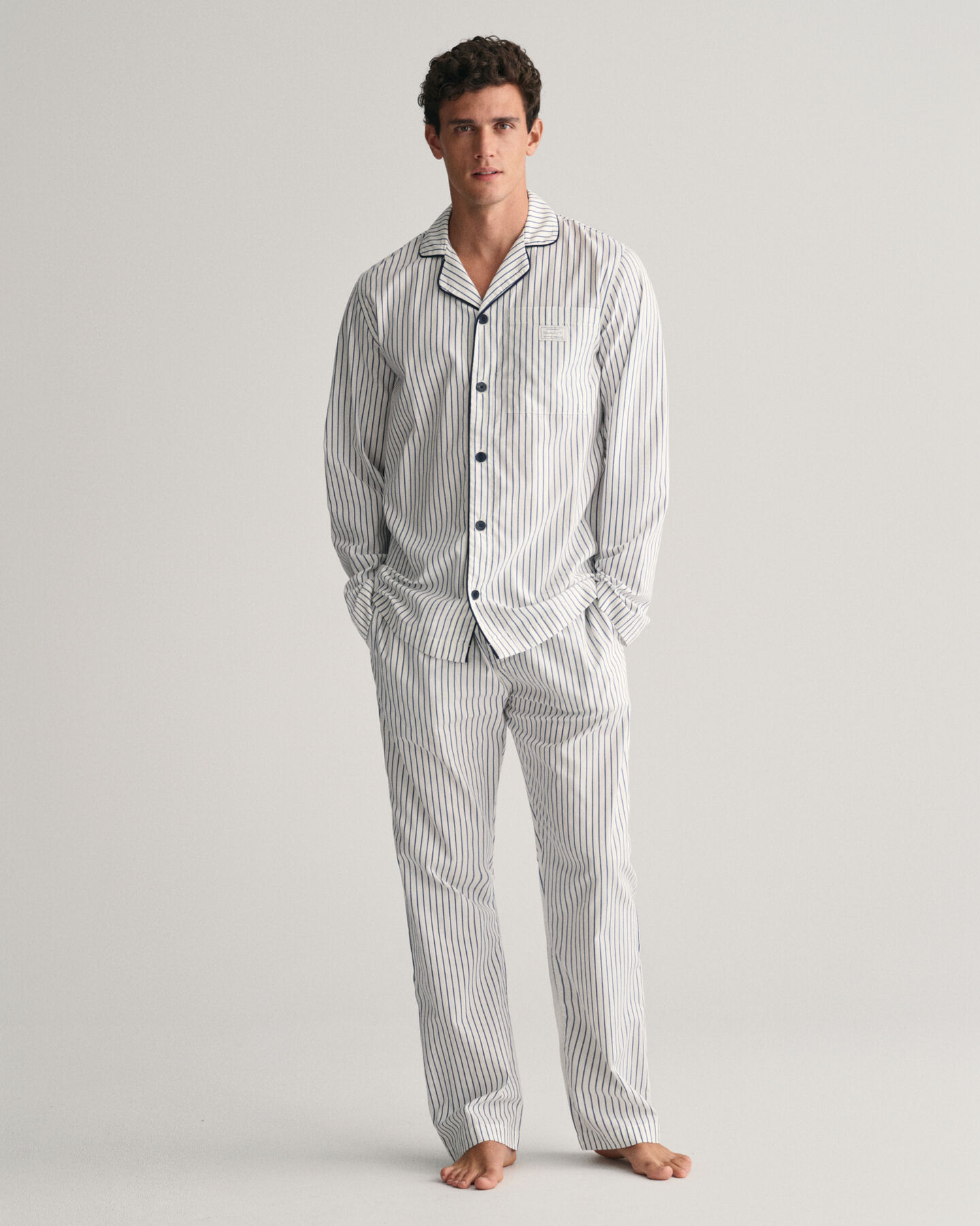 Raidalliset pyjamahousut ja ‑paita lahjapakkauksessa